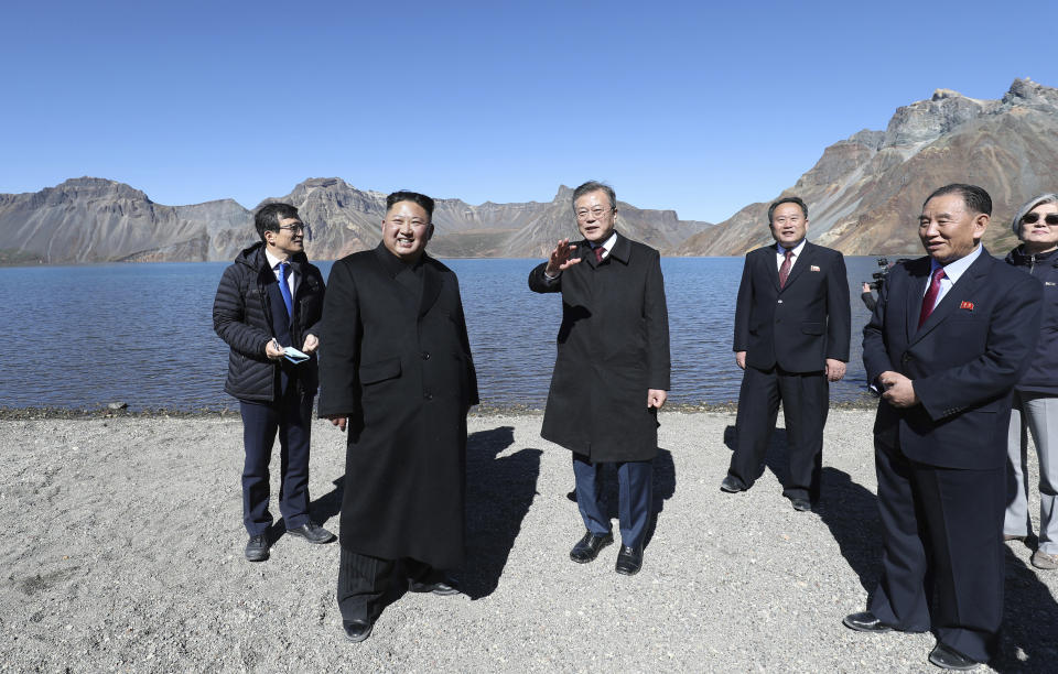 South Korean President Moon Jae-in, center right, and North Korean leader Kim Jong Un, center left, visit the Mount Paektu in North Korea, Thursday, Sept. 20, 2018. Moon and North Korean leader Kim Jong Un visited the picturesque and active volcano on the North Korean-Chinese border on Thursday and took a cable car to the crater lake called “Chonji" where they strolled together. (Pyongyang Press Corps Pool via AP)