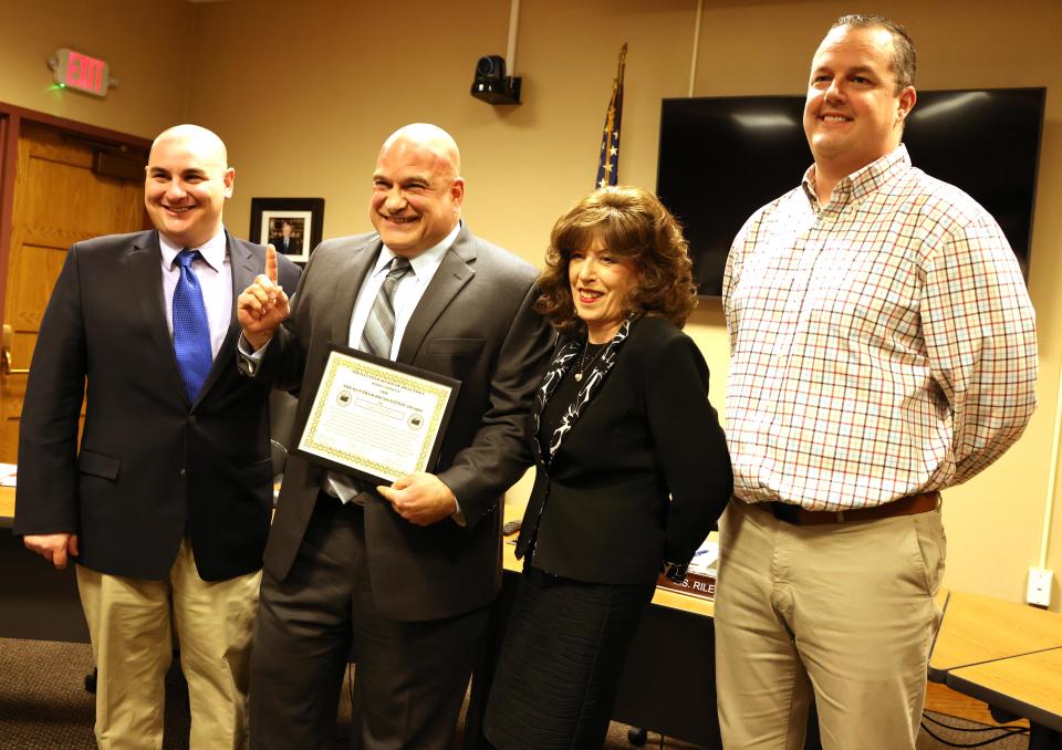 Raynham Selectmen present the "Raynham Recognition Award" to Police Det. Louis F. Pacheco, right, at Town Hall on Tuesday, Jan. 23, 2024. Pacheco is the Raynham school resource officer and B-R head football coach. From left, Selectman Joseph Pacheco, Louis F. Pacheco, Selectmen Chair Patricia Riley and Selectman Ken Collins.