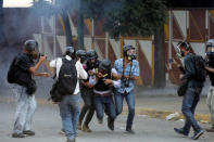 An injured member of the media is carried away during a rally against the government of Venezuela's President Nicolas Maduro and to commemorate May Day in Caracas, Venezuela May 1, 2019. REUTERS/Manaure Quintero