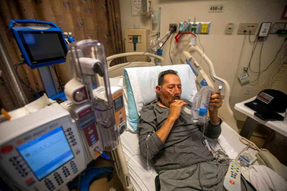 Covid positive patient Jorge Hernandez, 64, does his lung exercise with his incentive spirometer in the covid unit inside Little Company of Mary Medical Center in Torrance, CA. 