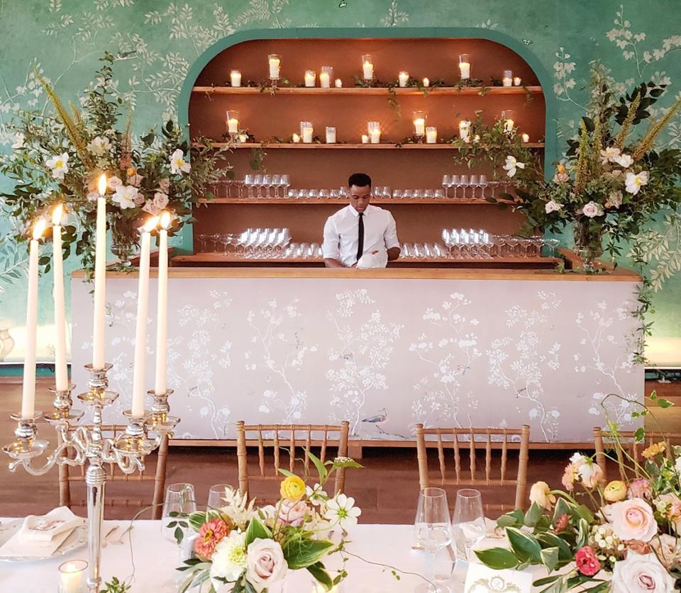 After the cocktail hour, we wanted our guests to feel as if they were walking back into our home as they entered our reception. Inspired by De Gournay, the walls of our tent were painted to look like wallpaper, and the tables were filled with sterling silver candelabras that illuminated the night.