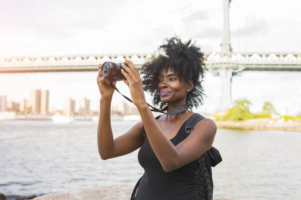 Woman looking at camera at the waterfront in NYC