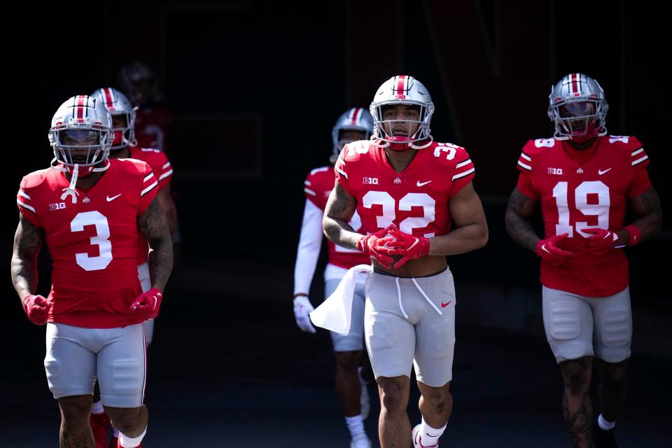 Apr 15, 2023; Columbus, Ohio, United States;  Ohio State Buckeyes running back Miyan Williams (3), running back TreVeyon Henderson (32) and running back Chip Trayanum (19) take the field during warmups for the Ohio State Buckeyes spring game at Ohio Stadium on Saturday morning. Mandatory Credit: Joseph Scheller-The Columbus Dispatch