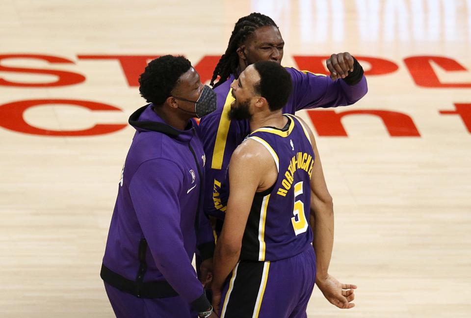 Lakers guard Talen Horton-Tucker, right, celebrates with teammates after a 101-99 victory over the New York Knicks.