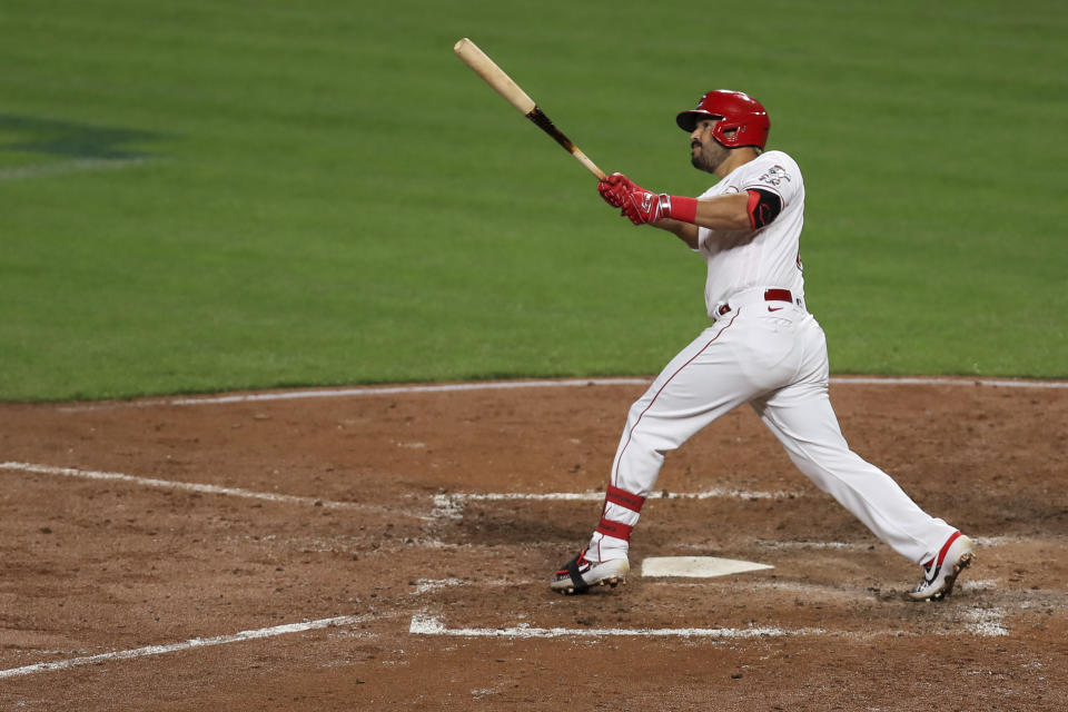 Cincinnati Reds' Eugenio Suarez watches his three-run home run during the fifth inning of the team's baseball game against the Milwaukee Brewers in Cincinnati, Wednesday, Sept. 23, 2020. (AP Photo/Aaron Doster)