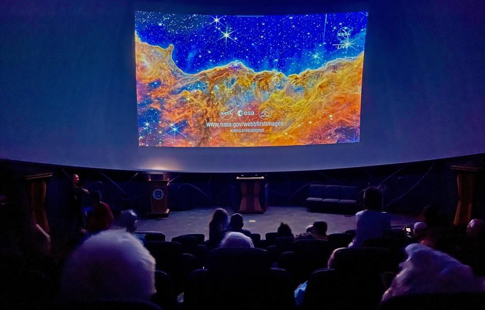Some 70 people enjoyed NASA's live broadcast of the James Webb Space Telescope reveals at Bradenton's Bishop Museum of Science and Nature's Planetarium, on July 12, 2022. Here one of five photos released, emerging stellar nurseries and individual stars in the Carina Nebula that were previously obscured. Images of "Cosmic Cliffs" showcase Webb's cameras' capabilities to peer through cosmic dust, shedding new light on how stars form. Objects in the earliest, rapid phases of star formation are difficult to capture, but Webb's extreme sensitivity, spatial resolution, and imaging capability can chronicle these elusive events.