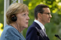 German Chancellor Angela Merkel, left, and Poland's Prime Minister Mateusz Morawiecki give a press conference in Warsaw, Poland, Saturday, Sept.11, 2021.Merkel is visiting the Polish capital Morawiecki at a time when Poland faces migration pressure on its eastern border with Belarus. (AP Photo/Czarek Sokolowski)