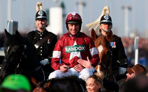 Davy Russell celebrates after riding Tiger Roll to victory in the Grand National - Credit: JASON ROBERTS/AFP/Getty Images