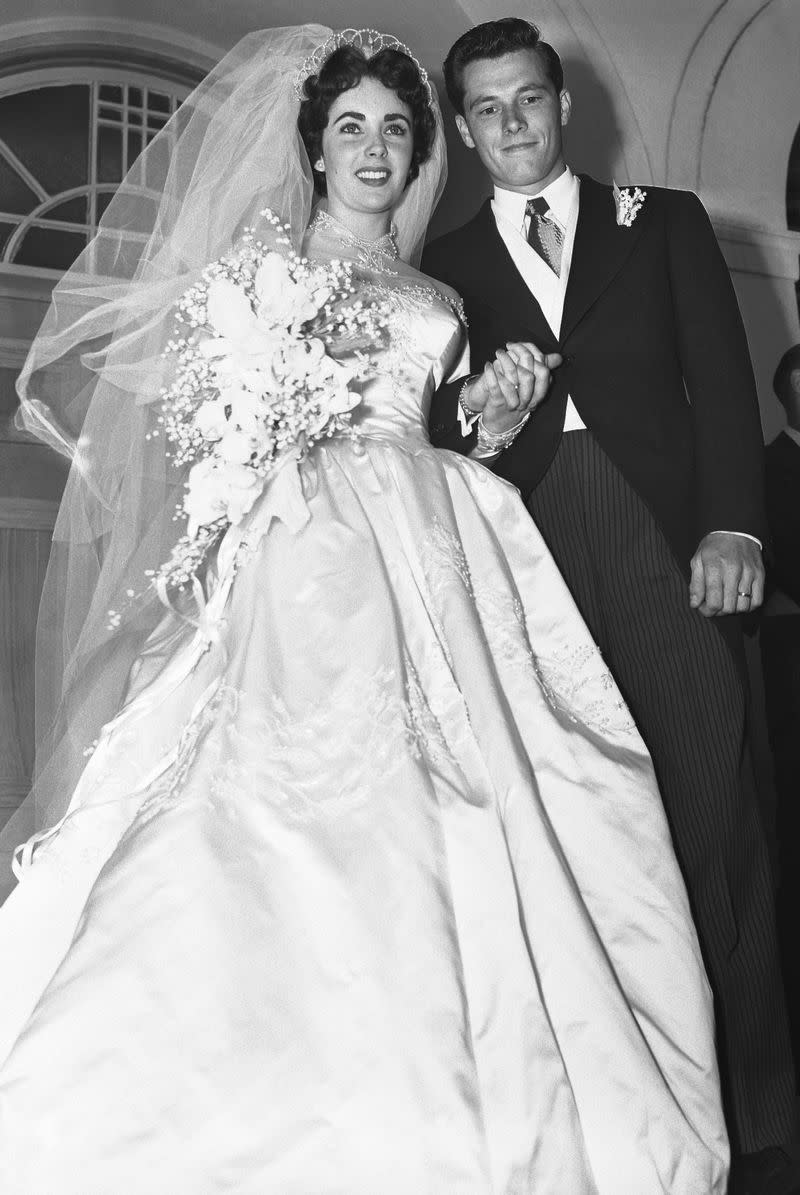 <p> American hotelier Conrad Hilton's son Nicky Hilton married Elizabeth Taylor when she was just 18 in a ceremony in Beverly Hills. </p> <p> MGM organized the fabulous event, and Elizabeth's dress was designed by famed costume maker Helen Rose. Her team of 15 people took an entire three months to create the gown out of satin and seed pearls, and the train is a whopping 15 yards. FYI, the couple divorced just eight months later. </p>
