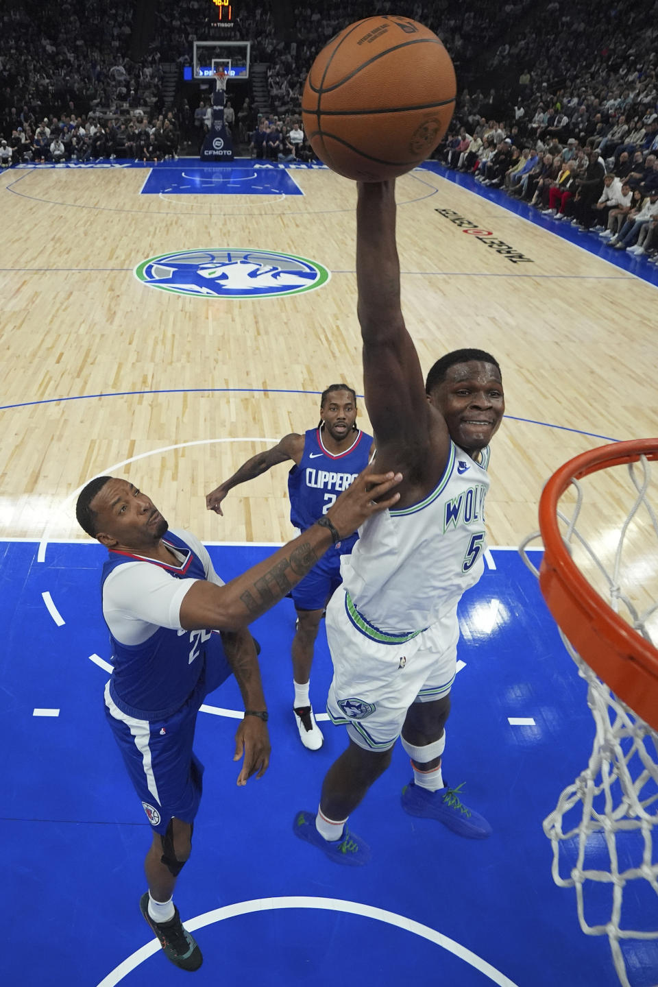 Minnesota Timberwolves guard Anthony Edwards (5) goes up for a dunk as Los Angeles Clippers guard Norman Powell, left, defends during the first half of an NBA basketball game, Sunday, March 3, 2024, in Minneapolis. (AP Photo/Abbie Parr)