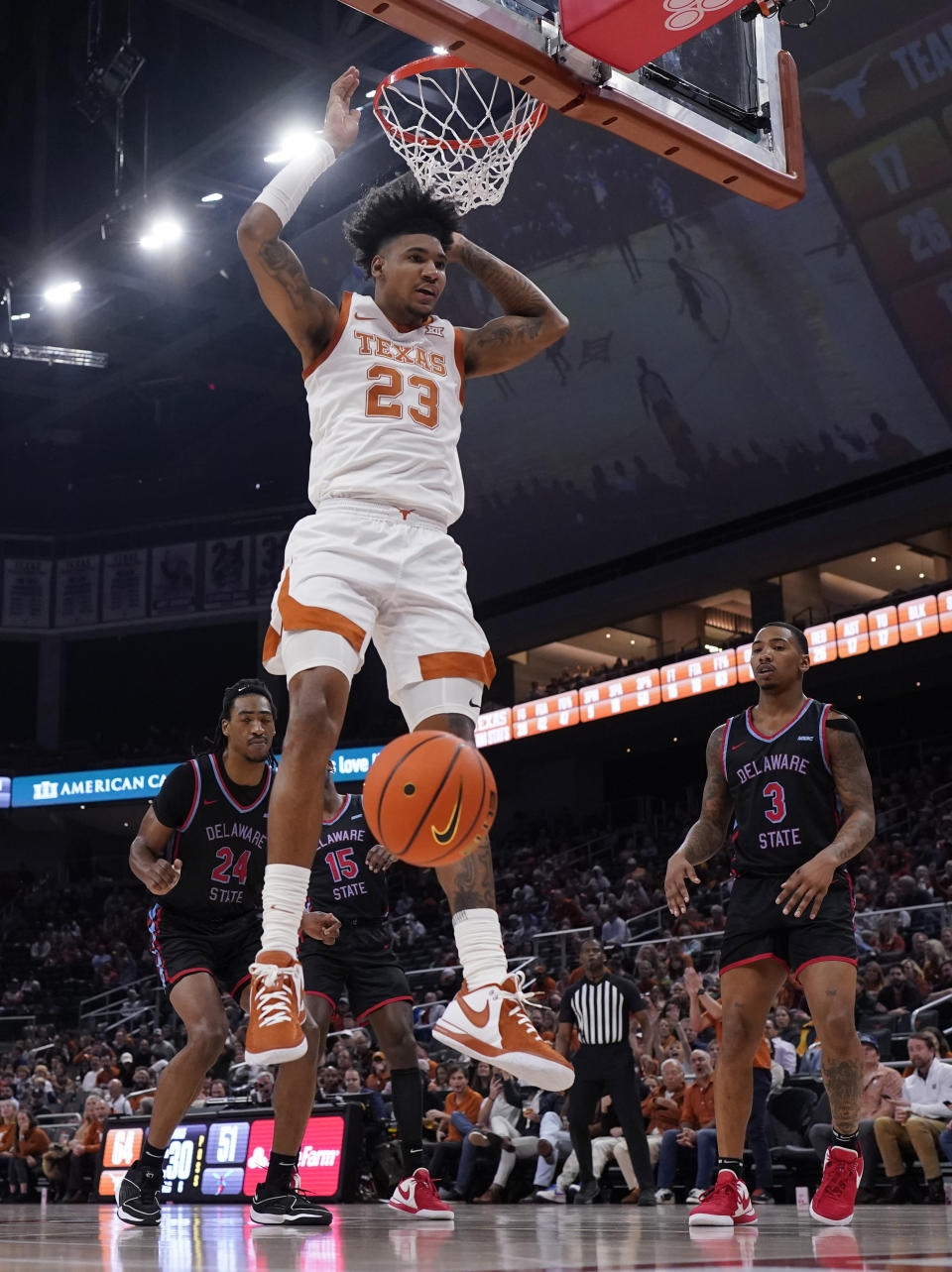 Texas forward Dillon Mitchell (23) scores against Delaware State during the second half of an NCAA college basketball game, Friday, Nov. 10, 2023, in Austin, Texas. (AP Photo/Eric Gay)