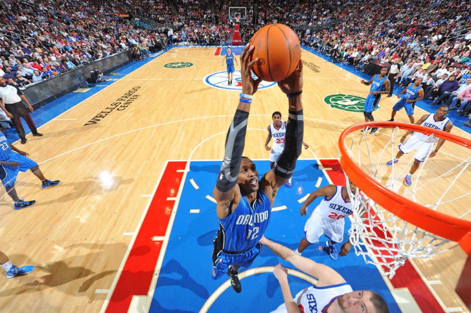 PHILADELPHIA, PA - APRIL 7: Dwight Howard #12 of the Orlando Magic dunks over Spencer Hawes #00 of the Philadelphia 76ers on April 7, 2012 at the Wells Fargo Center in Philadelphia, Pennsylvania. NOTE TO USER: User expressly acknowledges and agrees that, by downloading and/or using this Photograph, user is consenting to the terms and conditions of the Getty Images License Agreement. Mandatory Copyright Notice: Copyright 2012 NBAE