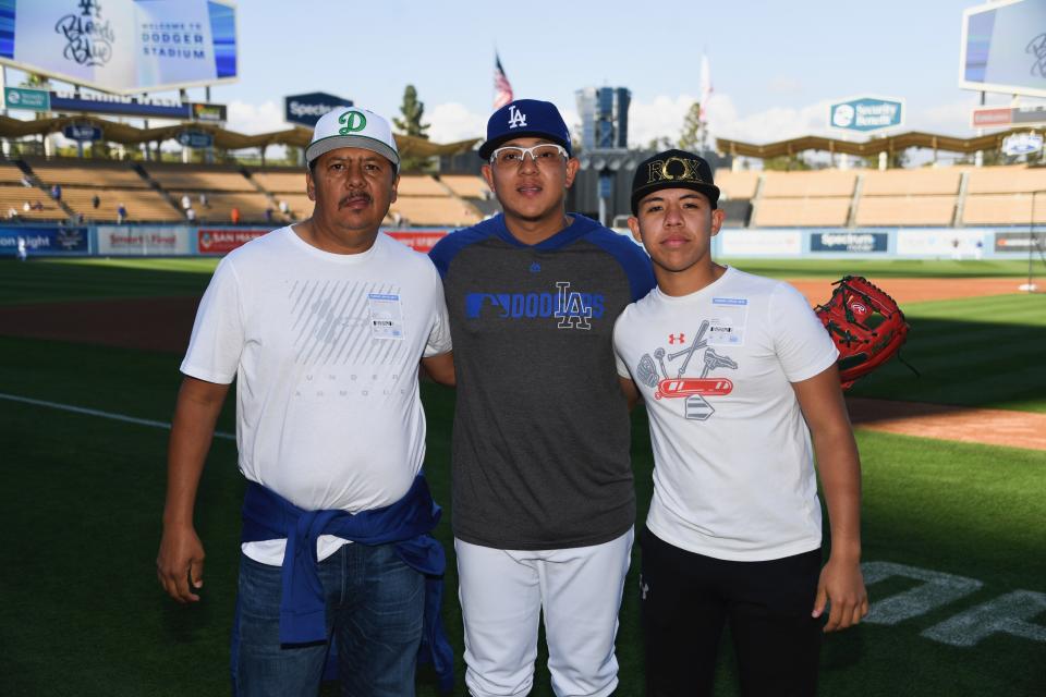 The Urias family: Julio's father, Carlos (left), and brother, Carlos (right). (Photo courtesy Jon SooHoo/Los Angeles Dodgers)