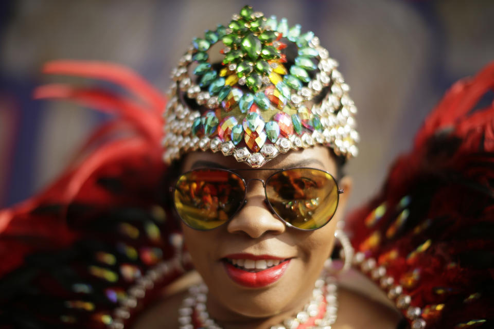 <p>A costumed reveller poses for a picture ahead of the parade during the Notting Hill Carnival in London, Monday, Aug. 27, 2018. (Photo: Tim Ireland/AP) </p>