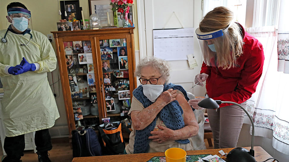 Jeannine Flamand receives her COVID-19 vaccine in the kitchen of her home in Warwick, R.I. (Suzanne Kreiter/The Boston Globe via Getty Images)