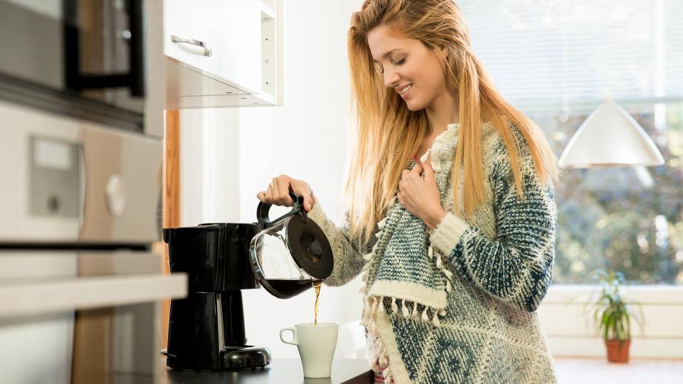 woman pouring coffee at home