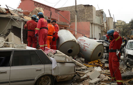 Firefighters search for the bodies of civilians who were killed after an air strike against Islamic State triggered a massive explosion in Mosul, Iraq, March 22, 2017. REUTERS/Stringer