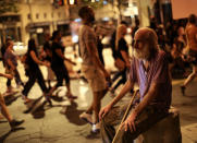 <p>A man watches demonstrators march during a protest in Atlanta on Friday, Sept. 23, 2016 in response to the police shooting deaths of Terence Crutch in Tulsa, Okla. and Keith Lamont Scott in Charlotte, N.C. (AP Photo/Branden Camp)</p>