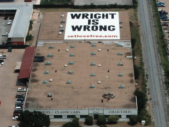 Wright is Wrong sign on top of Southwest Airlines HQ