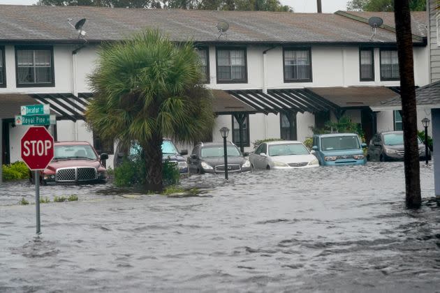 Vehicles sit in floodwater at the Palm Isle apartments in the aftermath of Hurricane Ian on Thursday in Orlando. (Photo: John Raoux/Associated Press)