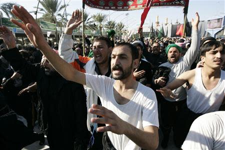 Shi'ite Muslim pilgrims take part in a ceremony to mark the religious ritual of Arbaeen in Kerbala, about 80 km (50 miles) southwest of Baghdad, December 24, 2013. REUTERS/Mushtaq Muhammed