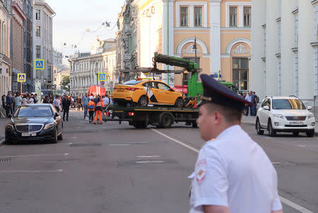 A damaged taxi, which ran into a crowd of people, is evacuated in central Moscow, Russia June 16, 2018. REUTERS/Staff