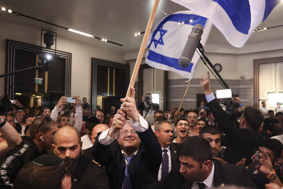 Israeli far-right lawmaker and the head of "Jewish Power" party, Itamar Ben-Gvir, waves the Israel flag after first exit poll results for the Israeli Parliamentary election at his party's headquarters in Jerusalem, Wednesday, Nov. 2, 2022. (AP Photo/Oren Ziv)