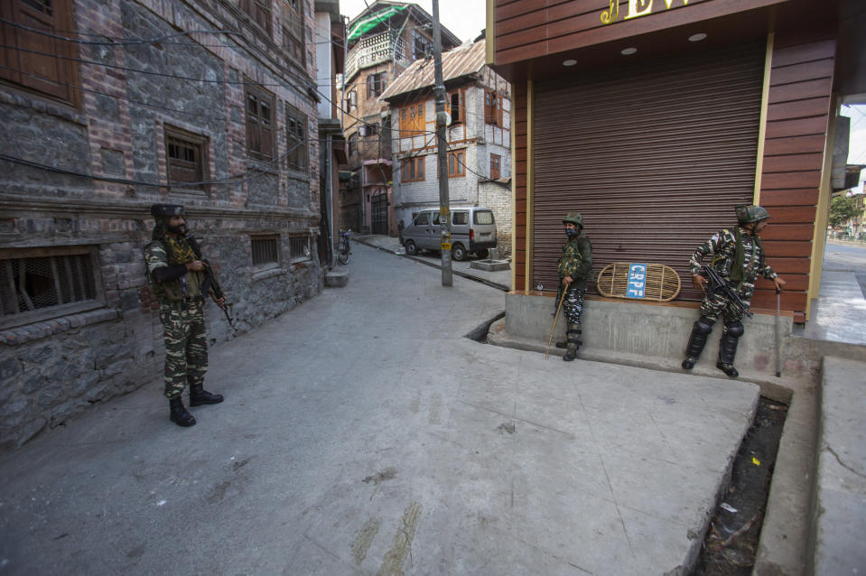 Indian paramilitary soldiers guard a deserted street in Srinagar, Indian controlled Kashmir, Sunday, Sept. 5, 2021. Authorities Sunday eased some restrictions that had been imposed after the death of top resistance leader Syed Ali Geelani. However, most shops and businesses stayed closed as government forces patrolled roads and streets in the city. (AP Photo/Mukhtar Khan)