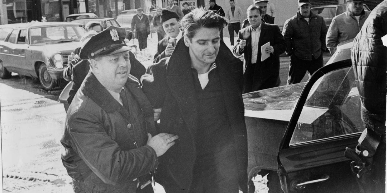 A police officer escorts a handcuffed Albert DeSalvo in February 1967.