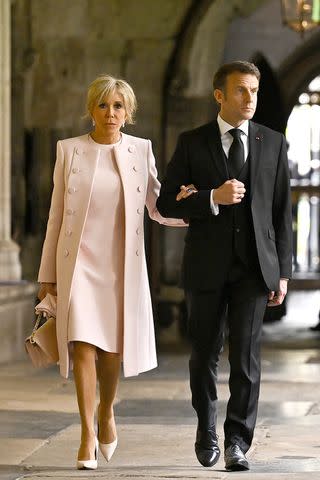 Ben Stansall - WPA Pool/Getty Brigitte and Emmanuel Macron arrive at the Coronation of King Charles III and Queen Camilla on May 6, 2023