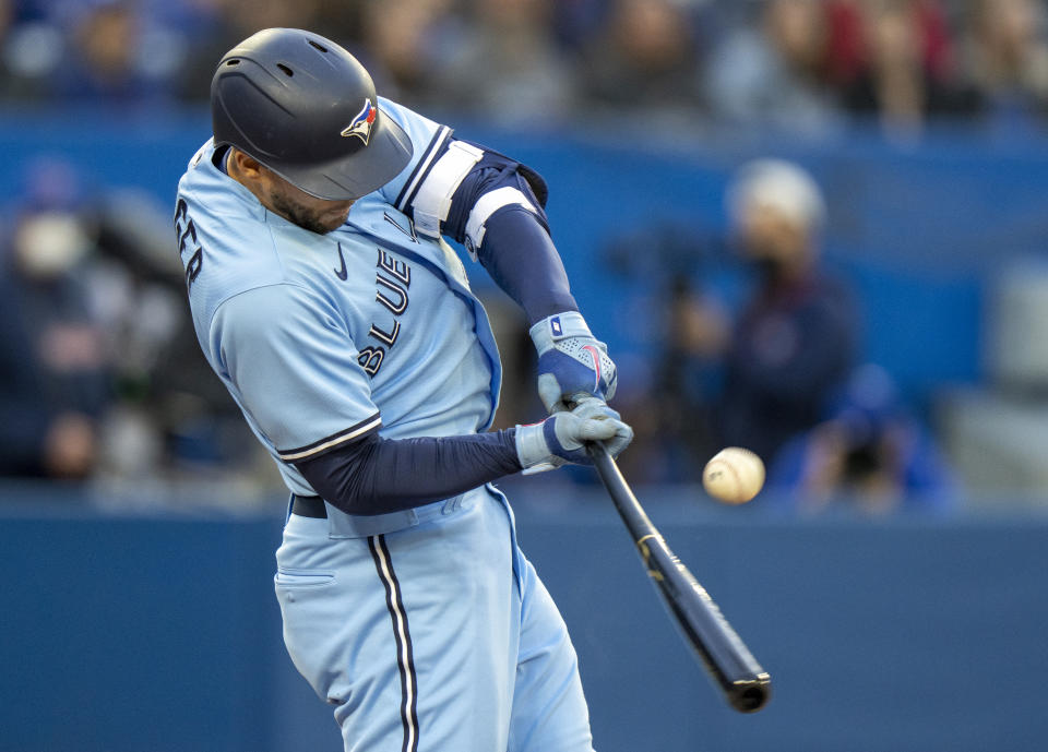 Toronto Blue Jays' George Springer (4) hits a three-run triple off Seattle Mariners starting pitcher Logan Gilbert (36) during the second inning of a baseball game Tuesday, May 17, 2022, in Toronto. (Frank Gunn/The Canadian Press via AP)