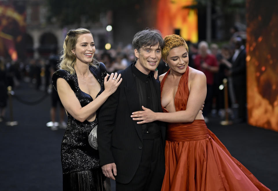 Emily, Cillian, and Florence embracing at an event