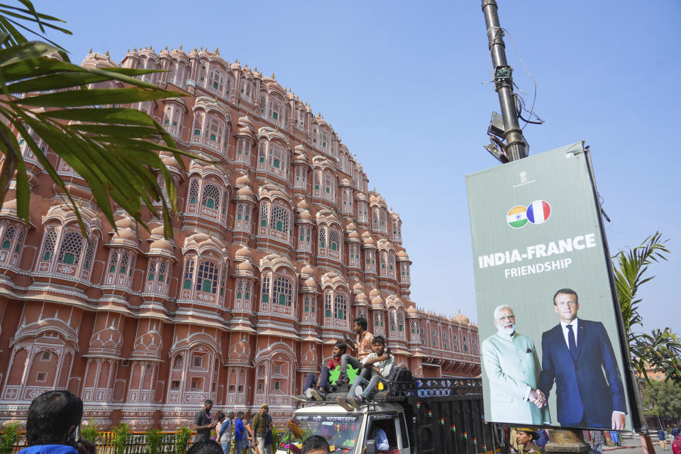 A billboard showing French President Emmanuel Macron with Indian Prime Minister Narendra Modi erected near the city landmark Hawa Mahal Palace, ahead of Macron's arrival in Jaipur, Rajasthan, India, Thursday, Jan.25, 2024. Macron will be the chief guest at India's annual republic day parade in New Delhi on Friday. (AP Photo/Deepak Sharma)