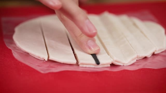 pressing chopstick on frozen prata strips to make youtiao shape
