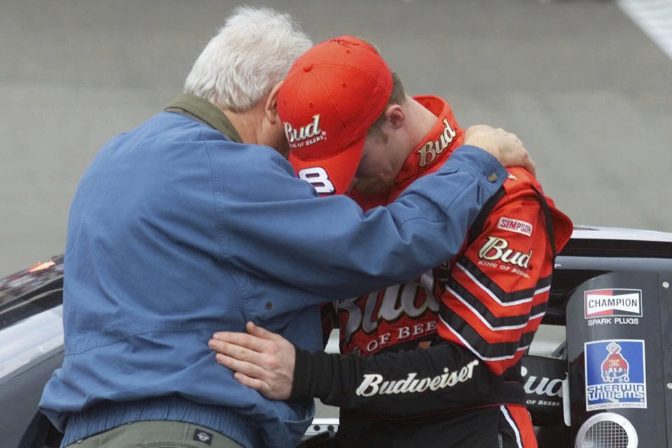 FILE - Dale Earnhardt Jr., right, prays with Motor Racing Outreach chaplain Max Helton, left, before climbing into his race car for the start of the Dura Lube 400 race at the North Carolina Speedway near Rockingham, N.C., Sunday, Feb. 25, 2001. (AP Photo/Chuck Burton, FIle)