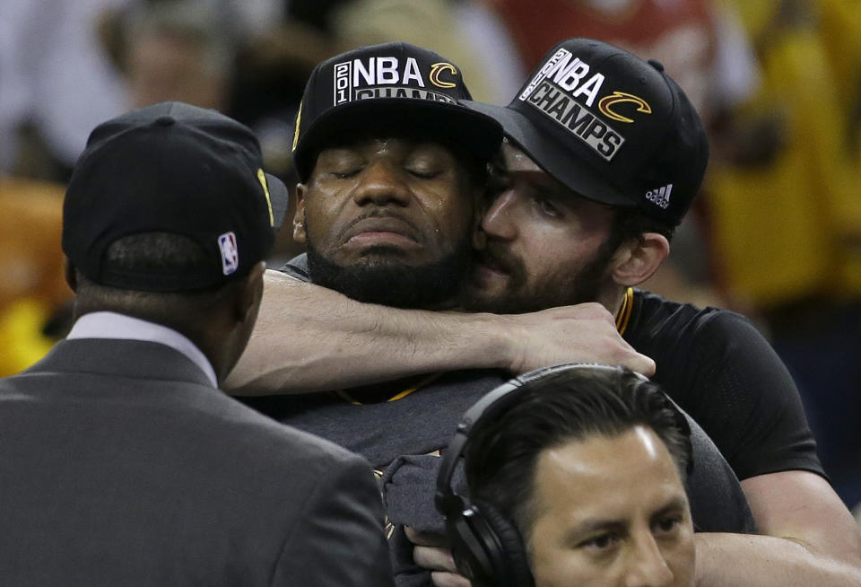 FILE - Cleveland Cavaliers forward LeBron James, back left, is hugged by Kevin Love after Game 7 of basketball's NBA Finals against the Golden State Warriors in Oakland, Calif., Sunday, June 19, 2016. Cavaliers forward Love, in an essay for The Associated Press, reflected on his years as James' teammate. James is about to pass Kareem Abdul-Jabbar for the NBA career scoring record. (AP Photo/Marcio Jose Sanchez, File)