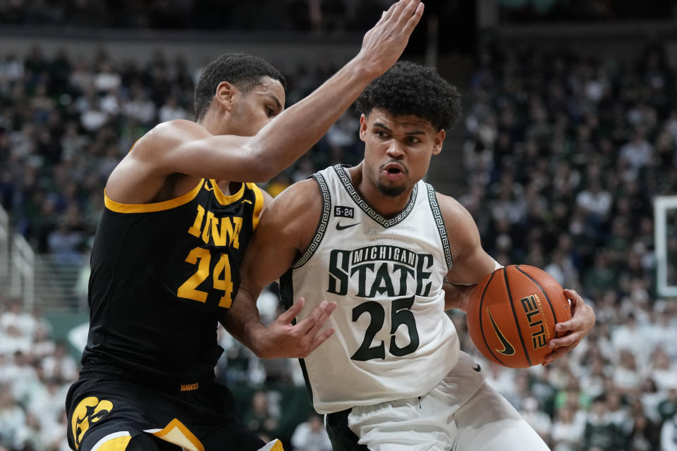 Michigan State forward Malik Hall (25) is defended by Iowa forward Kris Murray (24) during the second half of an NCAA college basketball game, Thursday, Jan. 26, 2023, in East Lansing, Mich. (AP Photo/Carlos Osorio)