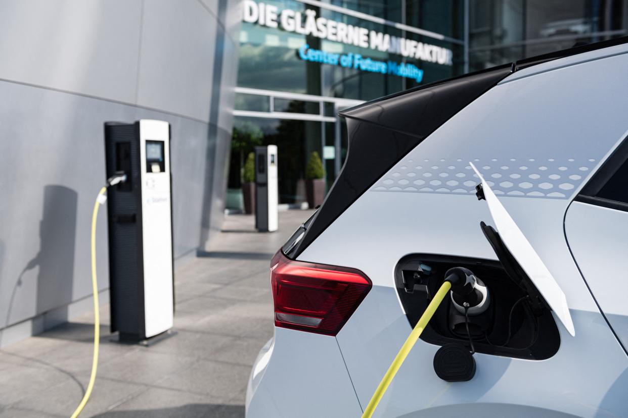 <p>Large-scale deployment of low-carbon technologies such as electric cars, wind turbines and solar panels will be key for tackling the climate crisis</p> (AFP via Getty Images)