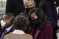 Former President Barack Obama and his wife Michelle talk with Ella Emhoff as they arrive for the 59th Presidential Inauguration at the U.S. Capitol for President-elect Joe Biden in Washington, Wednesday, Jan. 20, 2021. (AP Photo/Andrew Harnik)