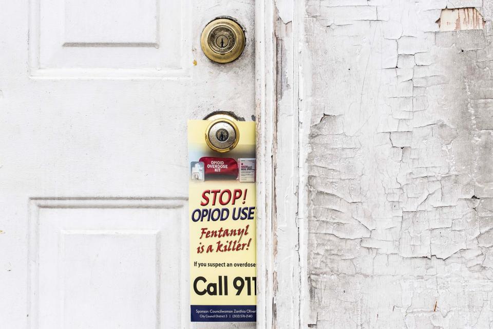 A "stop opioids use" door knocker hangs on a doorknob during an opioids outreach event along West 23rd and North Market streets in Wilmington on Wednesday, Dec. 6, 2023. Wilmington City Councilperson Zanthia Oliver, community members and organizations distributed door knockers and opioid rescue kits, which contained Narcan and dual fentanyl-xylazine test strips, to community residents as part of the "stop the use of opioids" event.