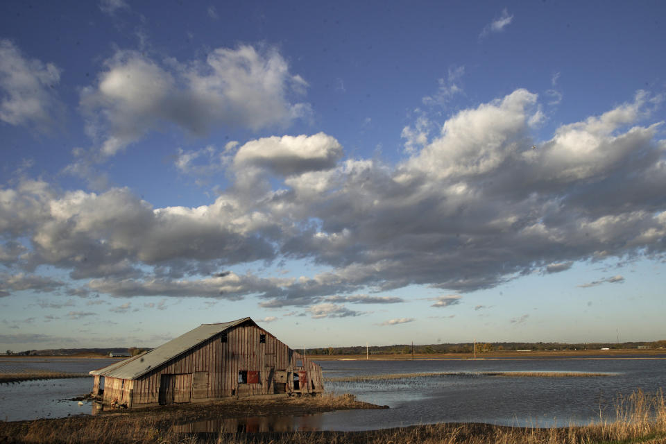 FILE- In this Oct. 22, 2019 photo, a barn sits in floodwaters in Pacific Junction, Iowa. Nebraska, Iowa, Kansas and Missouri are joining forces for a study that will look for ways the states can limit flooding along the Missouri River and give them information about how wetter weather patterns could require changes to the federal government's management of the basin's reservoirs. The states are pooling their money to pay for half of a $400,000 study with the U.S. Army Corps of Engineers to measure how much water flows down the Missouri River. (AP Photo/Nati Harnik)