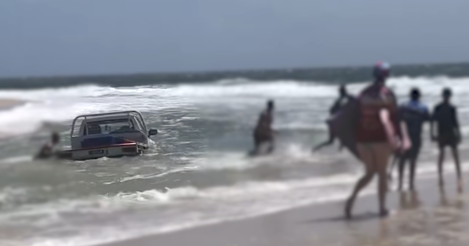 Onlookers quickly jumped into the water the rescue the vehicle (pictured). 