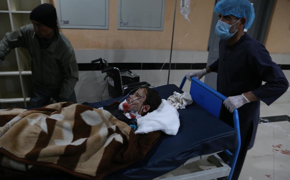 People move an injured child at a local hospital in Kabul, Afghanistan, on May 8, 2021, after dozens were killed by three consecutive explosions outside a school in western part of Kabul. / Credit: Sayed Mominzadah/Xinhua/Getty