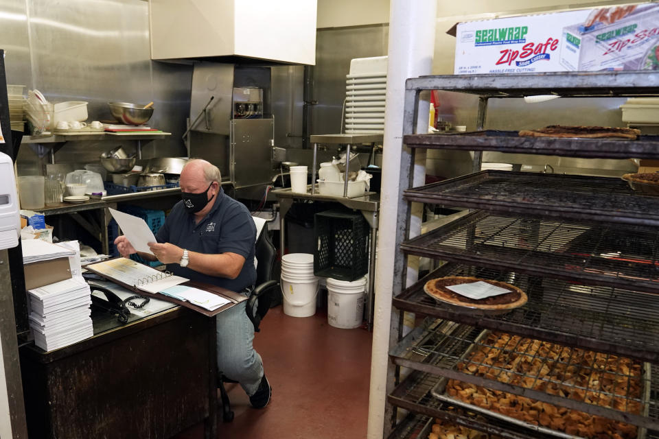 *** Hold For Story *** Pie 'N Burger owner Michael Osborn sits in his office in his restaurant Tuesday, Dec. 1, 2020, in Pasadena, Calif. Pasadena has become an island in the center of the nation's most populous county, where a surge of COVID-19 cases last week led to a three-week end to outdoor dining and California's first stay-home order since the pandemic began to spread across the state in March. (AP Photo/Marcio Jose Sanchez)