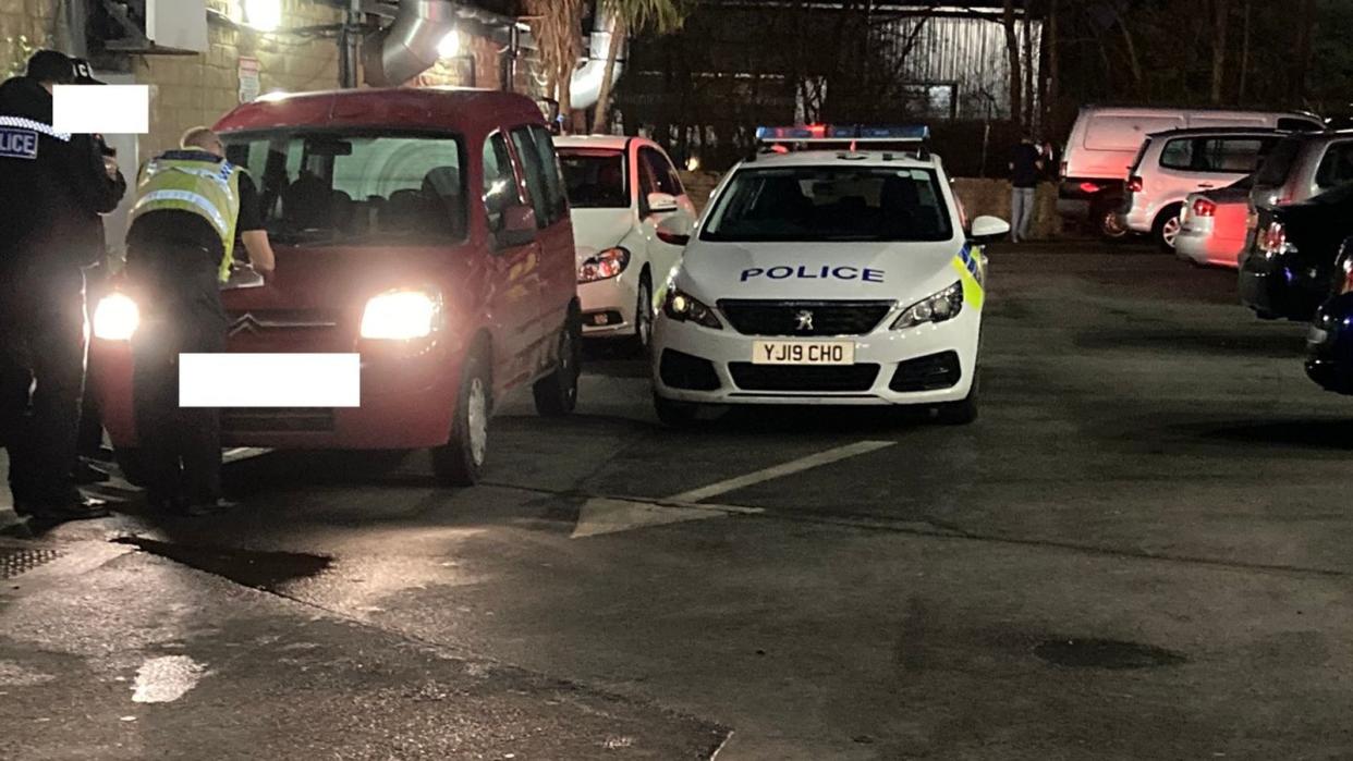 Police officers speak to a man who shouted at two undercover officers. (West Yorkshire Police)