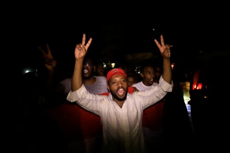 Sudanese people chant slogans as they march during a demonstration in Khartoum