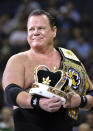 FILE - In this March 23, 2019, file photo, wrestler Jerry "The King" Lawler stands on the court during a break in play in the first half of an NBA basketball game between the Minnesota Timberwolves and the Memphis Grizzlies in Memphis, Tenn. While real sports have shut down in the wake of the coronavirus pandemic, WWE has pressed on and is set to run this weekend its first WrestleMania in an empty arena. (AP Photo/Brandon Dill, File)