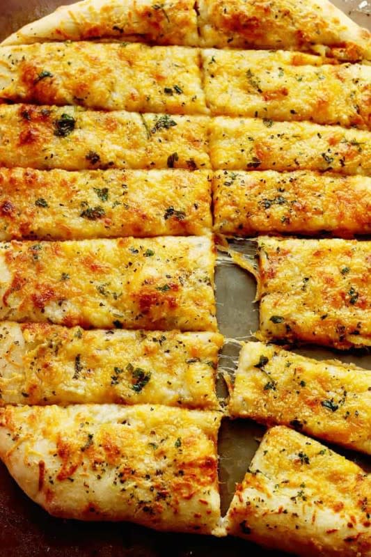 <p>Grandbaby Cakes</p><p>These homemade breadsticks will put your local pizzeria’s to shame! A wonderfully tender yet crispy dough is topped with an addictive garlic butter sauce and finished with gooey cheese. </p><p><strong>Get the recipe:</strong> <a href="https://grandbaby-cakes.com/cheese-breadsticks/" rel="nofollow noopener" target="_blank" data-ylk="slk:Cheese Breadsticks;elm:context_link;itc:0;sec:content-canvas" class="link rapid-noclick-resp"><strong>Cheese Breadsticks</strong></a></p>