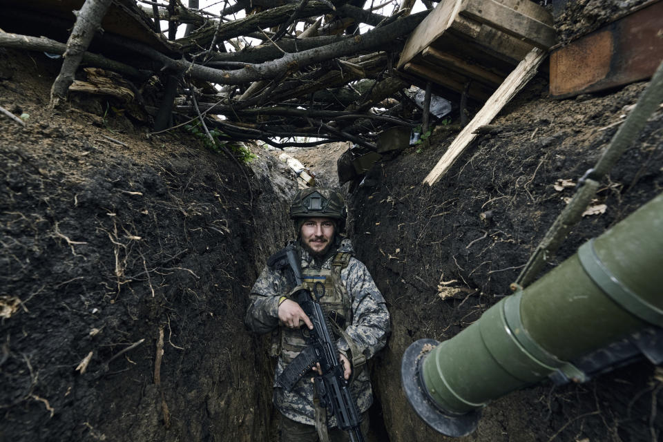A Ukrainian soldier stands in a trench on the frontline near Avdiivka, an eastern city where fierce battles against Russian forces have been taking place, in the Donetsk region, Ukraine, Friday, April 28, 2023. (AP Photo/Libkos)