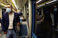 Rui Brito, a worker with a disability, travels in a subway after work in Porto